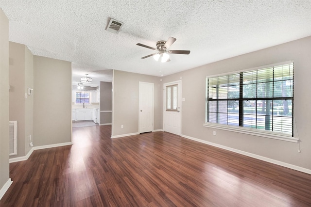 1002 Williams St, Cleveland, TX 77327 - unfurnished living room with ceiling fan, dark wood finished floors, and a textured ceiling