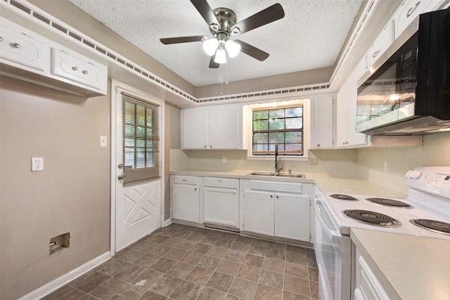 1002 Williams St, Cleveland, TX 77327 - kitchen with white range with electric stovetop, stainless steel microwave, white cabinets, a textured ceiling, and ceiling fan