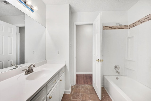 1002 Williams St, Cleveland, TX 77327 - bathroom featuring vanity, shower / washtub combination, a textured ceiling, and tile patterned floors
