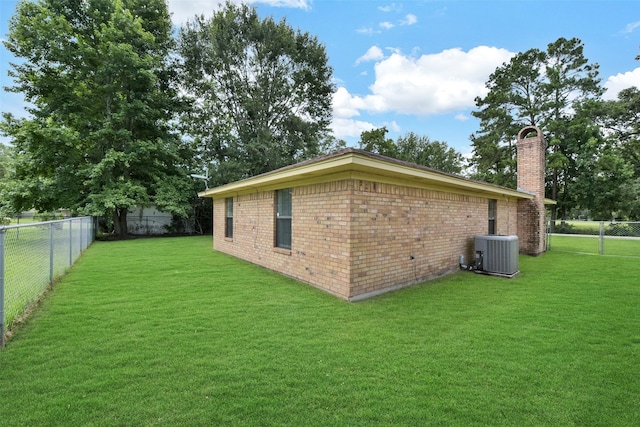 1002 Williams St, Cleveland, TX 77327 - view of home's exterior featuring a fenced backyard, a chimney, and brick siding