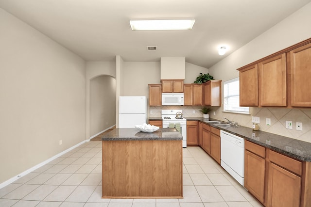 20234 Goss Hollow Ln, Katy, TX 77449 - kitchen with white appliances, a center island, light tile patterned floors, tasteful backsplash, and vaulted ceiling