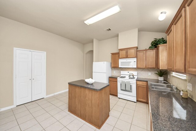 20234 Goss Hollow Ln, Katy, TX 77449 - kitchen with white appliances, a kitchen island, light tile patterned floors, tasteful backsplash, and vaulted ceiling