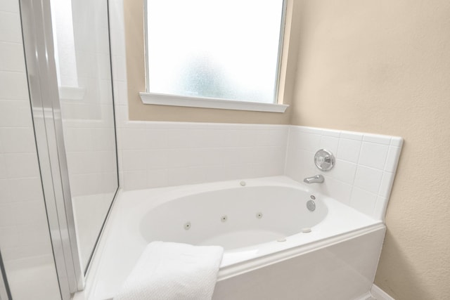 20234 Goss Hollow Ln, Katy, TX 77449 - full bath featuring a whirlpool tub, a textured wall, and a shower