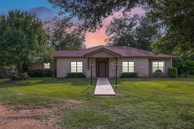 194 2 Mile Ln, Smithville, TX 78957 - view of front facade with stone siding and a yard