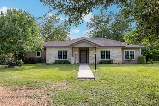 194 2 Mile Ln, Smithville, TX 78957 - view of front of home featuring stone siding and a front yard