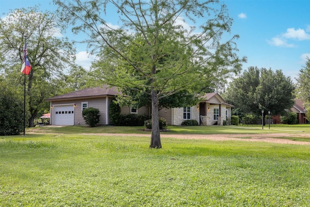 194 2 Mile Ln, Smithville, TX 78957 - view of front of home with stone siding, a front yard, and an attached garage