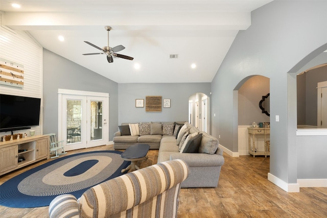 194 2 Mile Ln, Smithville, TX 78957 - living area with arched walkways, a ceiling fan, high vaulted ceiling, light wood finished floors, and beamed ceiling