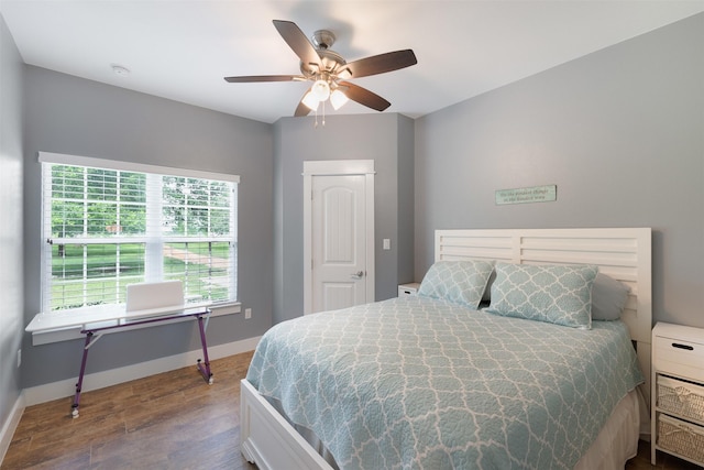 194 2 Mile Ln, Smithville, TX 78957 - bedroom featuring dark wood-style flooring and a ceiling fan