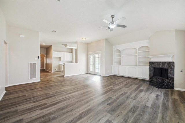 12319 Georgetown Park Ct, Houston, TX 77058 - unfurnished living room featuring ceiling fan, built in features, a premium fireplace, and dark wood finished floors