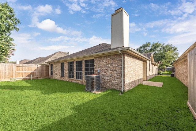 12319 Georgetown Park Ct, Houston, TX 77058 - back of house with a chimney, brick siding, a fenced backyard, and roof with shingles
