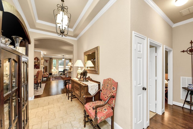 9419 Pecos Pass Ct, Cypress, TX 77433 - foyer entrance featuring crown molding, arched walkways, a chandelier, wood finished floors, and a raised ceiling