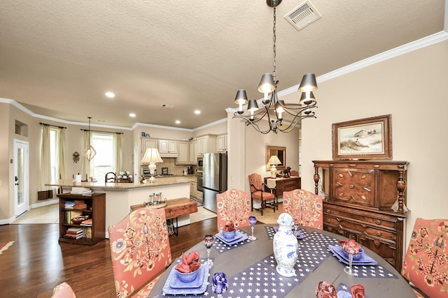 9419 Pecos Pass Ct, Cypress, TX 77433 - dining space featuring crown molding, a chandelier, light wood finished floors, recessed lighting, and a textured ceiling