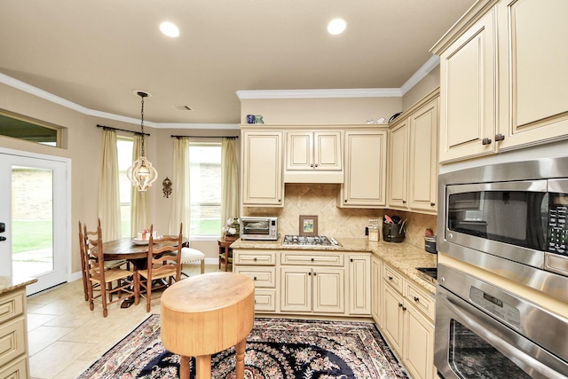 9419 Pecos Pass Ct, Cypress, TX 77433 - kitchen with cream cabinets, stainless steel appliances, ornamental molding, backsplash, and recessed lighting