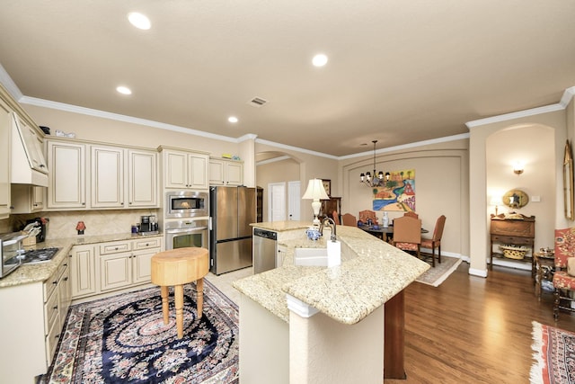 9419 Pecos Pass Ct, Cypress, TX 77433 - kitchen featuring stainless steel appliances, arched walkways, an island with sink, backsplash, and a chandelier