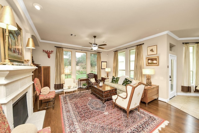 9419 Pecos Pass Ct, Cypress, TX 77433 - living area featuring a premium fireplace, crown molding, ceiling fan, and wood finished floors