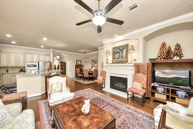 9419 Pecos Pass Ct, Cypress, TX 77433 - living room with wood finished floors, ceiling fan, crown molding, arched walkways, and recessed lighting