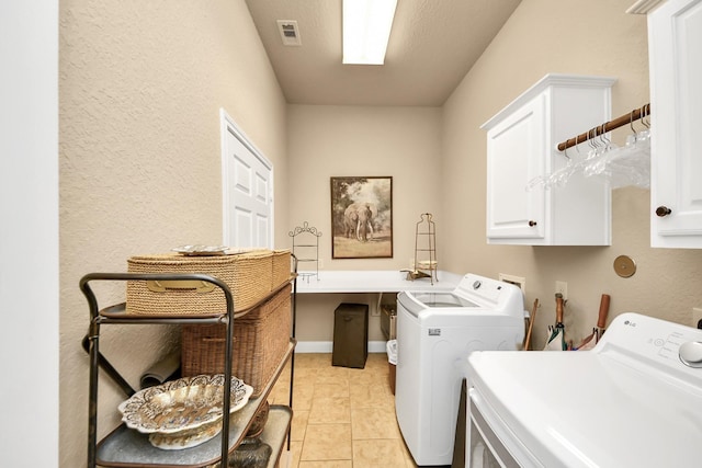 9419 Pecos Pass Ct, Cypress, TX 77433 - washroom featuring cabinet space, independent washer and dryer, a textured wall, and light tile patterned floors
