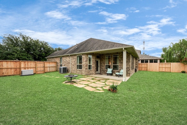 9419 Pecos Pass Ct, Cypress, TX 77433 - back of house with a shingled roof, a fenced backyard, an outdoor fire pit, and a patio