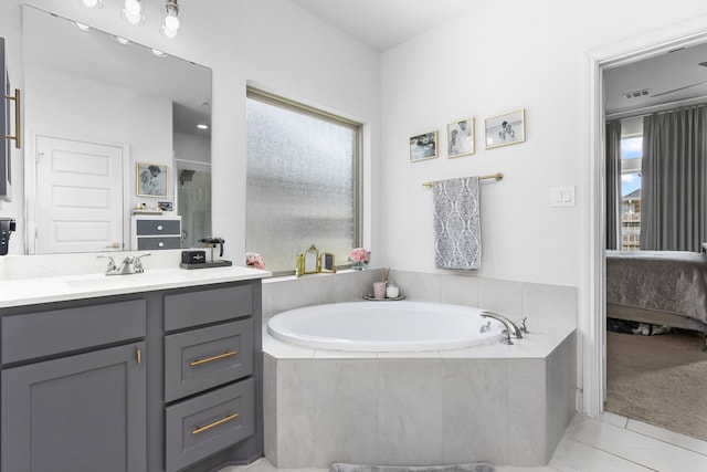 29126 Sage Meadow Trl, Fulshear, TX 77441 - ensuite bathroom with vanity, a garden tub, and tile patterned flooring
