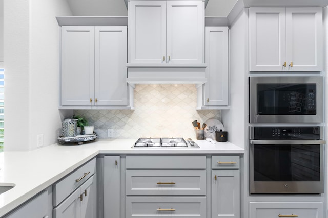 29126 Sage Meadow Trl, Fulshear, TX 77441 - kitchen with appliances with stainless steel finishes, light countertops, backsplash, and custom range hood