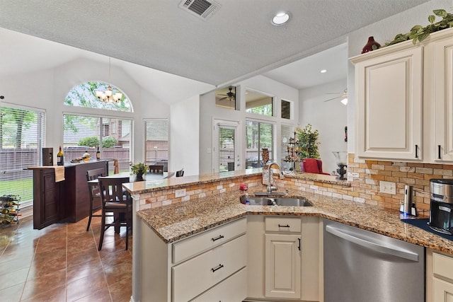 3330 Lake Island Dr, Montgomery, TX 77356 - kitchen featuring dishwasher, a ceiling fan, a peninsula, healthy amount of natural light, and lofted ceiling