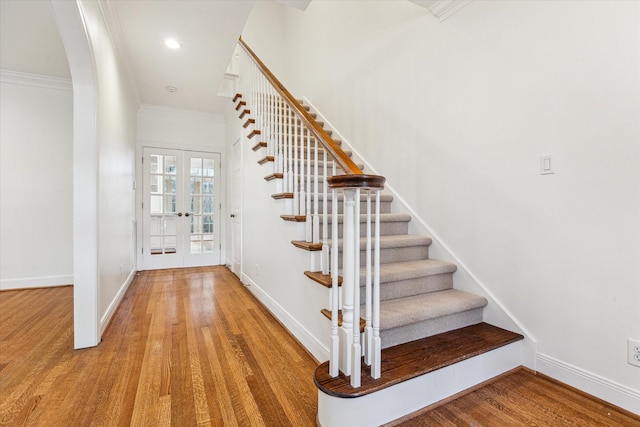 1976 Vermont St, Houston, TX 77019 - stairs featuring wood finished floors, french doors, arched walkways, and crown molding