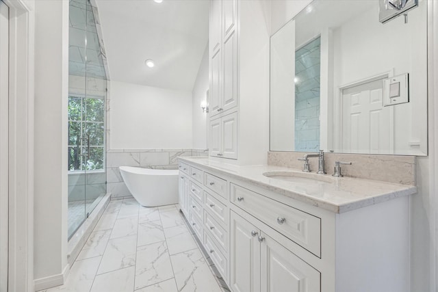 1976 Vermont St, Houston, TX 77019 - bathroom featuring marble look tiles, vanity, a freestanding bath, tile walls, and recessed lighting