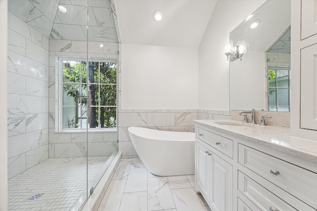 1976 Vermont St, Houston, TX 77019 - bathroom featuring marble finish flooring, a soaking tub, tile walls, healthy amount of natural light, and vanity