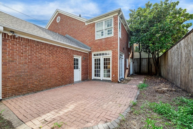 1976 Vermont St, Houston, TX 77019 - back of house with a fenced backyard, a patio, brick siding, and roof with shingles