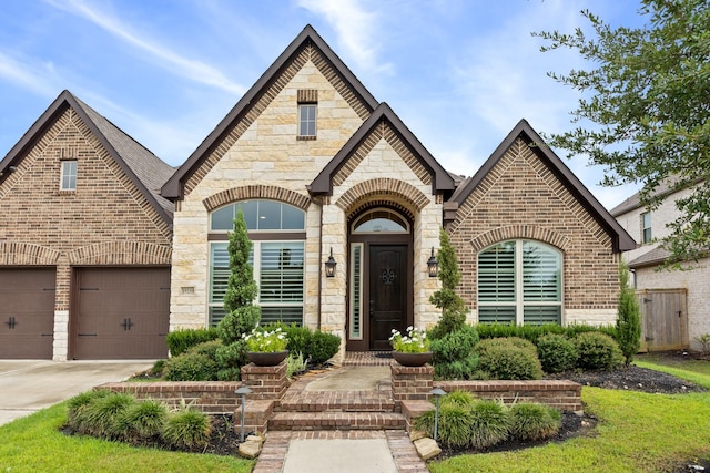19219 Spotted Bass Ln, Cypress, TX 77433 - view of front of home with brick siding, concrete driveway, a garage, and stone siding