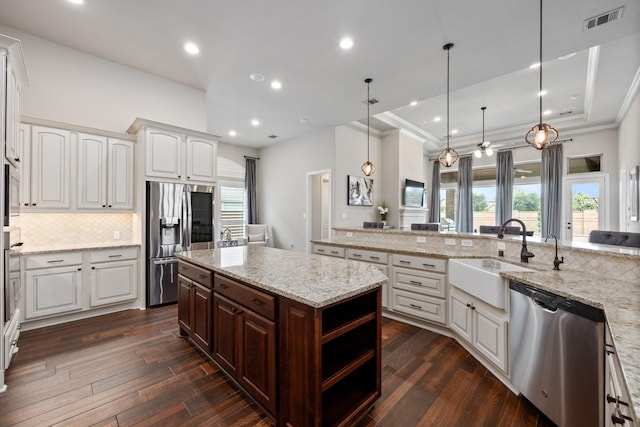 19219 Spotted Bass Ln, Cypress, TX 77433 - kitchen featuring appliances with stainless steel finishes, decorative backsplash, white cabinetry, dark wood-style floors, and recessed lighting