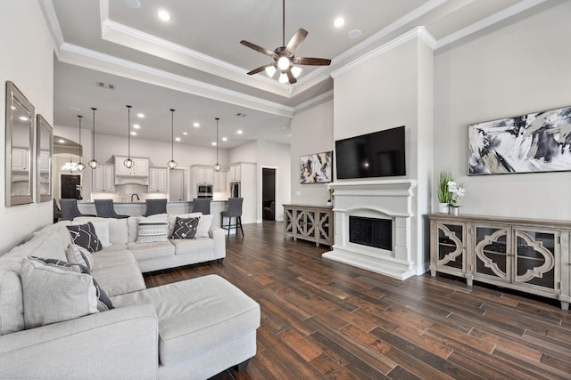 19219 Spotted Bass Ln, Cypress, TX 77433 - living area featuring ceiling fan, crown molding, dark wood finished floors, a raised ceiling, and recessed lighting