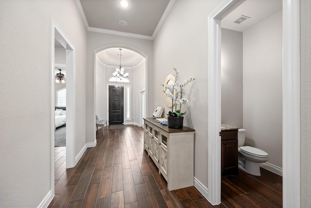 19219 Spotted Bass Ln, Cypress, TX 77433 - entrance foyer with ornamental molding, dark wood-style floors, arched walkways, and a chandelier