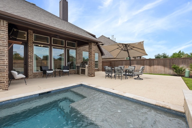19219 Spotted Bass Ln, Cypress, TX 77433 - view of pool with a patio area and exterior kitchen