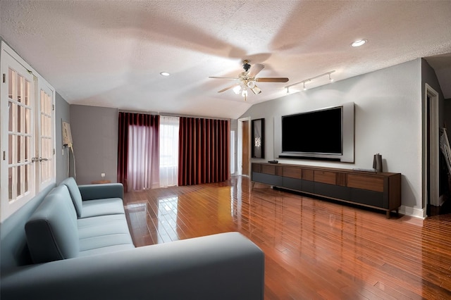4610 Brinkman St, Houston, TX 77018 - living room featuring a textured ceiling, a ceiling fan, hardwood / wood-style flooring, vaulted ceiling, and recessed lighting