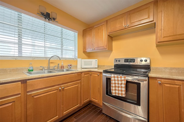 4610 Brinkman St, Houston, TX 77018 - kitchen featuring stainless steel electric stove, white microwave, light countertops, and dark wood finished floors