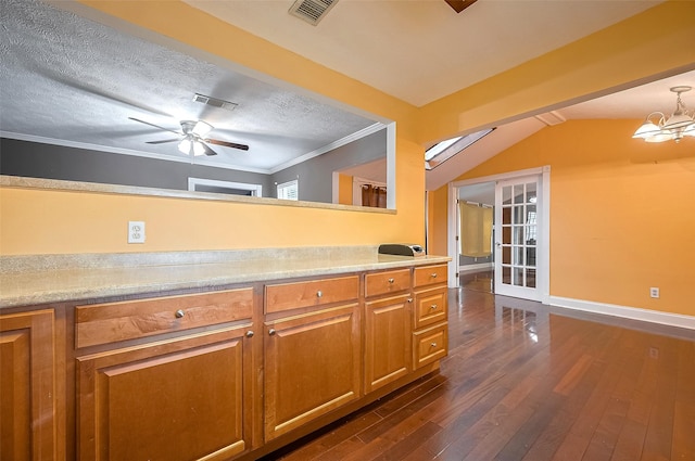 4610 Brinkman St, Houston, TX 77018 - kitchen with dark wood-type flooring, light countertops, brown cabinetry, ornamental molding, and a ceiling fan