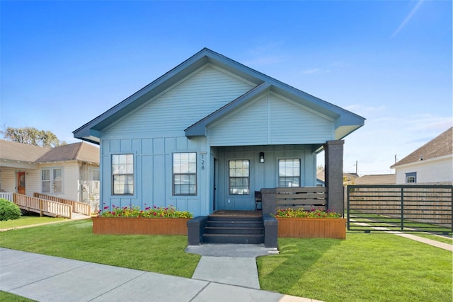 128 N Jenkins St, Houston, TX 77003 - view of front facade with board and batten siding and covered porch
