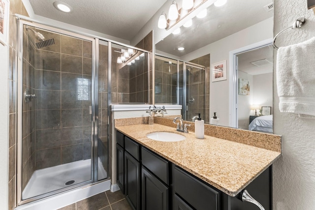 4663 Trembling Forest Ln, Houston, TX 77092 - full bathroom with connected bathroom, vanity, tile patterned floors, a shower stall, and a textured ceiling