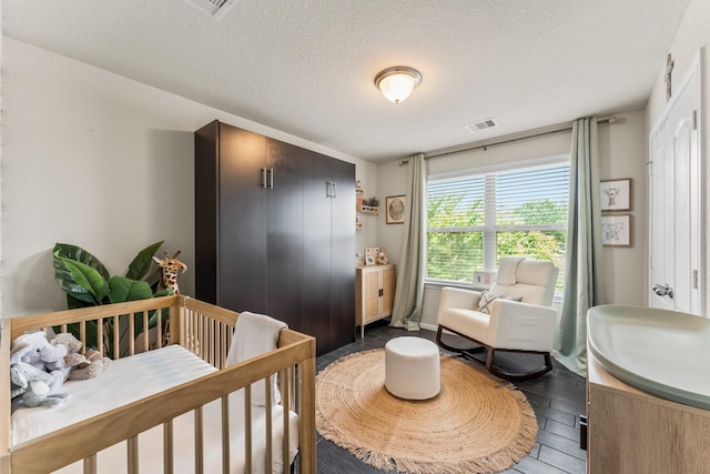 4663 Trembling Forest Ln, Houston, TX 77092 - bedroom featuring dark wood-style flooring and a textured ceiling