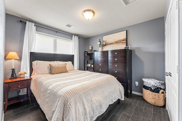4663 Trembling Forest Ln, Houston, TX 77092 - bedroom with wood finish floors, a textured wall, and a textured ceiling