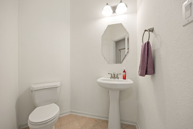 6230 Ledger Ln, Missouri City, TX 77459 - half bathroom with toilet and tile patterned floors