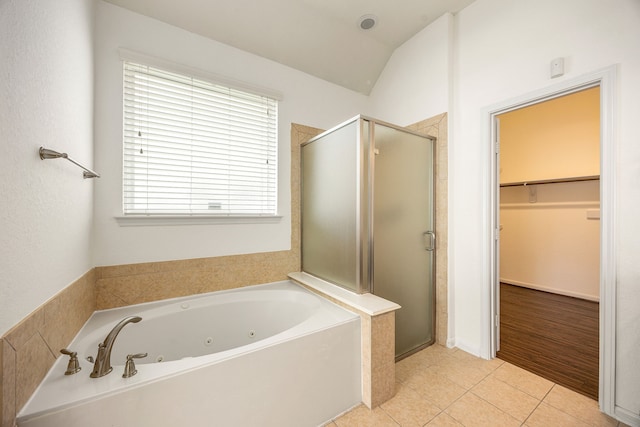 6230 Ledger Ln, Missouri City, TX 77459 - bathroom with a stall shower, a whirlpool tub, a spacious closet, tile patterned flooring, and vaulted ceiling