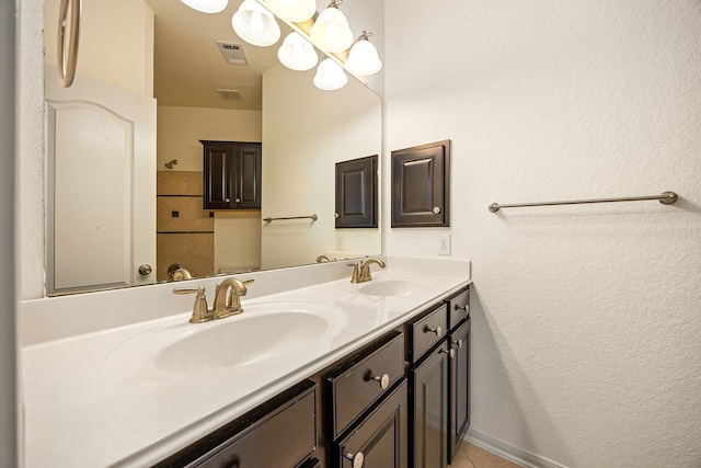 6230 Ledger Ln, Missouri City, TX 77459 - bathroom with double vanity, tile patterned flooring, and a textured wall