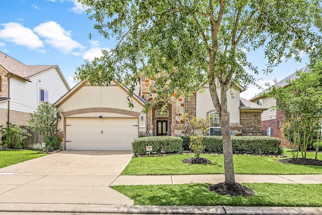 6230 Ledger Ln, Missouri City, TX 77459 - view of front of home featuring stucco siding, a front lawn, a garage, concrete driveway, and stone siding