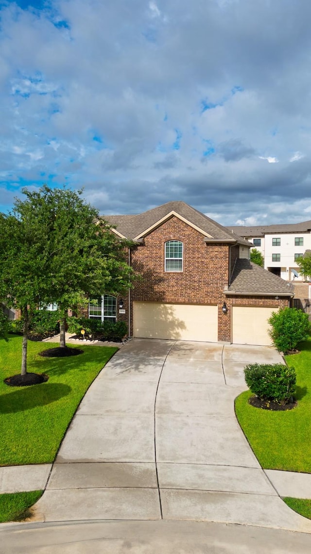 19334 St Winfred Dr, Spring, TX 77379 - view of front of home featuring brick siding, concrete driveway, an attached garage, a shingled roof, and a front yard