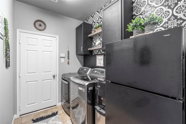 19334 St Winfred Dr, Spring, TX 77379 - laundry area featuring washer and clothes dryer, cabinet space, and light tile patterned floors