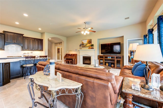 3411 Brampton Island Dr, Katy, TX 77494 - living room with ceiling fan, arched walkways, recessed lighting, and light tile patterned flooring