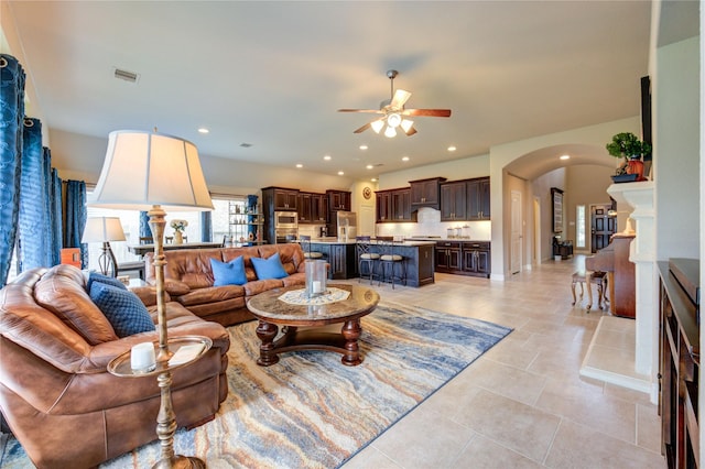 3411 Brampton Island Dr, Katy, TX 77494 - living area with arched walkways, ceiling fan, recessed lighting, and light tile patterned flooring