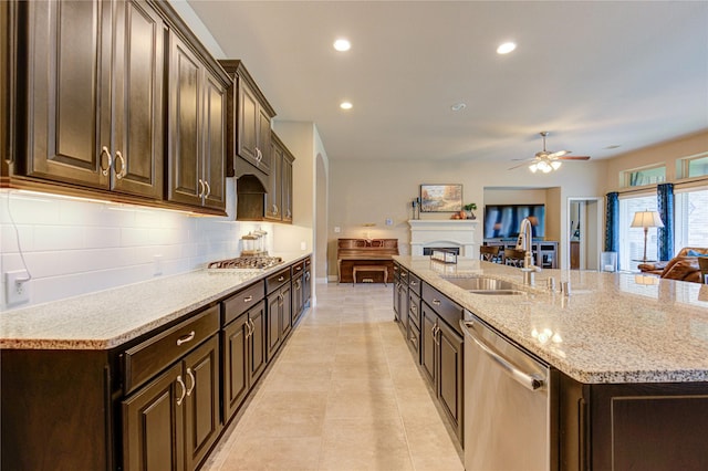 3411 Brampton Island Dr, Katy, TX 77494 - kitchen featuring stainless steel dishwasher, a ceiling fan, tasteful backsplash, open floor plan, and a large island